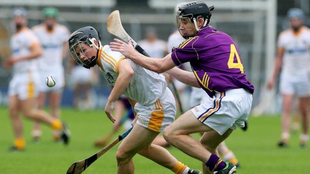 Daniel McKiernan of Antrim comes under pressure from Wexford opponent Eoin Conroy during the semi-final at Thurles