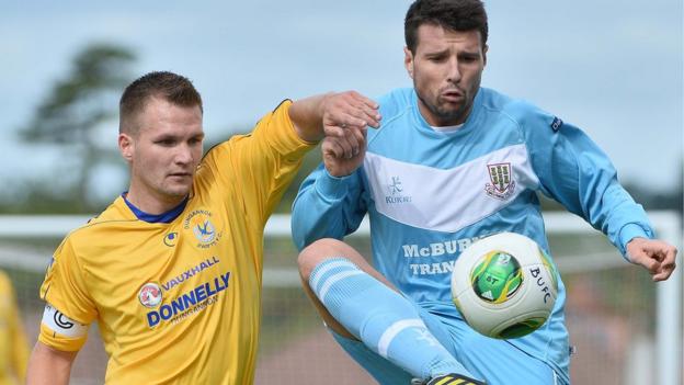 Ryan Harpur of Dungannon Swifts competes against Ballymena United opponent Alan Davidson - the Sky Blues won 2-1