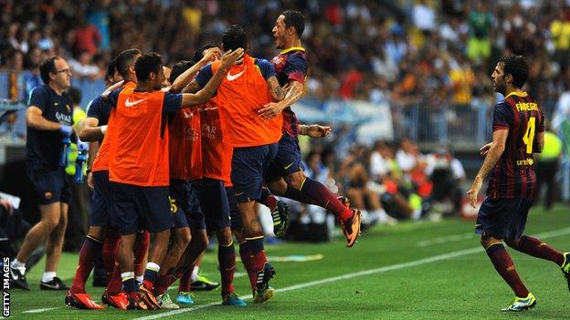 Adriano celebrates after scoring for Barcelona against Malaga