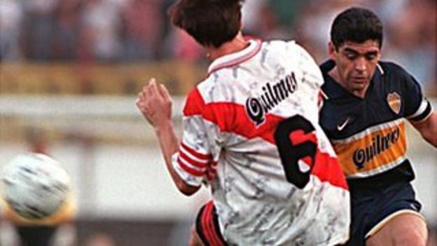 Boca Juniors playmaker Diego Maradona (right) takes on Eduardo Berizo of River Plate in a Superclassico in 1997