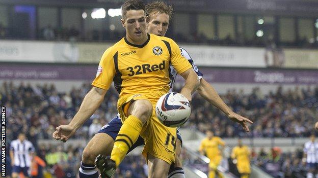 Newport’s Conor Washington battles for the ball with West Brom’s Craig Dawson.