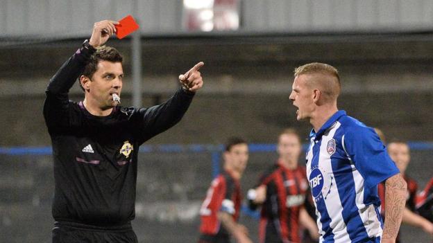 Referee Andrew Davey shows a red card to Coleraine's Aaron Canning at Ballycastle Road