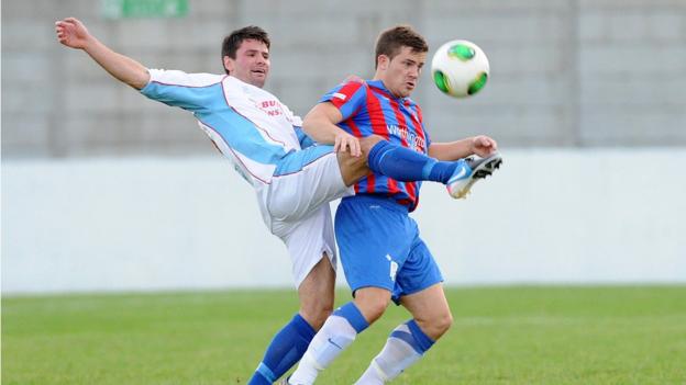 Ballymena's Mark McCullagh attempts to dispossess Neil Dougan of Ards at Dixon Park