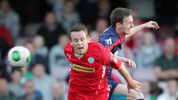 Jaimie McGovern and Gary Twigg challenge for the ball as Portadown defeat champions Cliftonville at Solitude