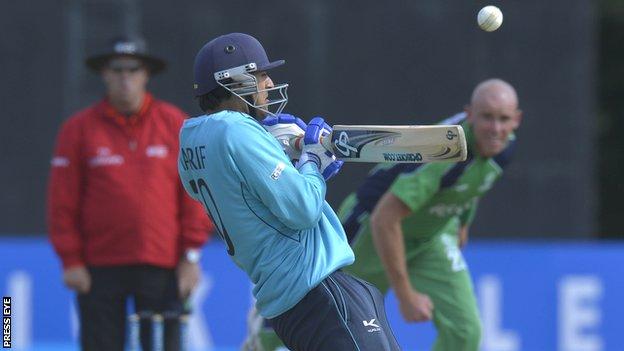 Scotland's Safyaan Sharif plays a shot with Trent Johnston bowling