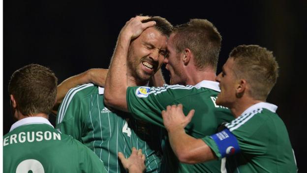 Central defender Gareth McAuley is congratulated after heading home Northern Ireland's equaliser to make it 1-1