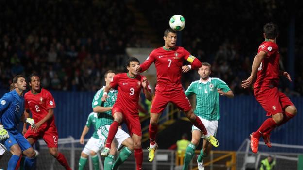 Cristiano Ronaldo clears the ball for Portugal before going on to score a second-half hat-trick at Windsor Park