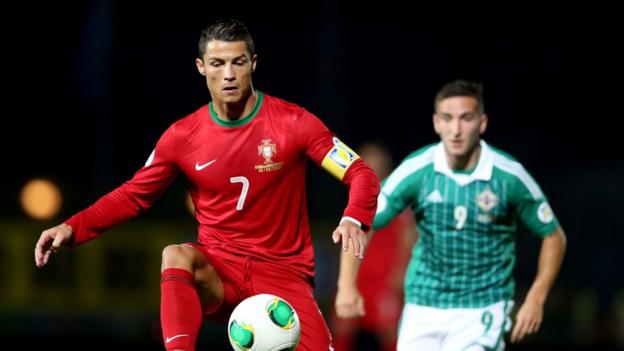 Portugal hat-trick hero Cristiano Ronaldo shields the ball from Martin Paterson