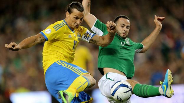 Zlatan Ibrahimovic and Marc Wilson contend for possession at the Aviva Stadium
