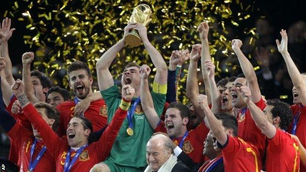 Spain team members celebrate with the World Cup trophy in 2010