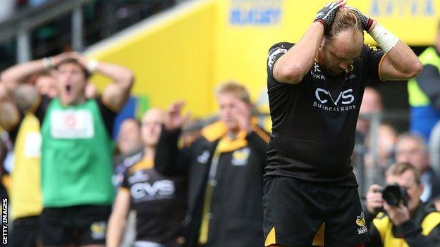 Wasps fly-half Andy Goode holds his head after his last-gasp conversion attempt hits the post