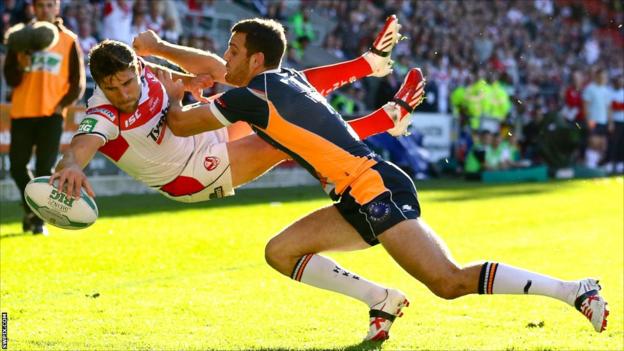 Tommy Makinson goes airborne to score a try for St Helens against Hull KR