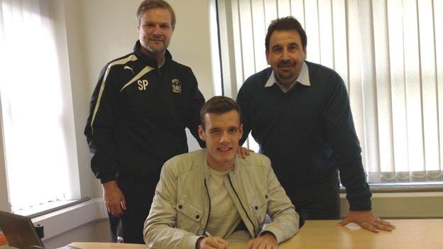 Stuart Urqhart signs for Coventry, watched by boss Steven Pressley and development director Steve Waggott