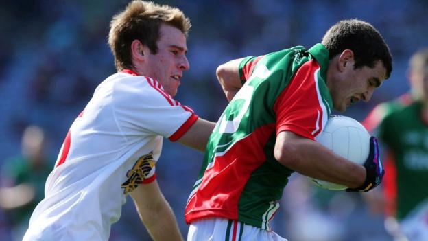 Shae Hamill of Tyrone attempts to halt a charge by Mayo forward Tommy Conroy at Croke Park