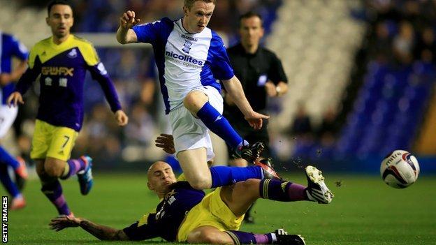 Jonjo Shelvey of Swansea City tackles Shane Ferguson of Birmingham City during the Capital One Cup Third Round match