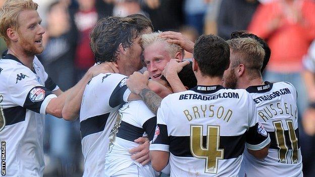 Derby's players crowd around Will Hughes after the midfielder's late strike seals victory over Leeds United