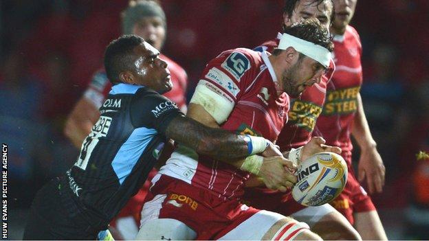 Scarlets forward Josh Turnbull is tackled by Glasgow's Tiko Matawalu