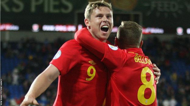 Craig Bellamy helps Simon Church celebrate the goal that gives Wales a 1-0 win