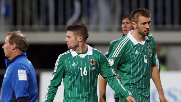 Northern Ireland players Oliver Norwood and Gareth McAuley trudge off the pitch after the 2-0 defeat by Azerbaijan