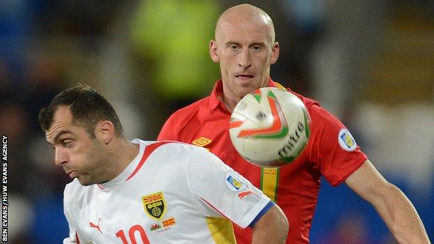 Goran Pandev of Macedonia and James Collins of Wales compete