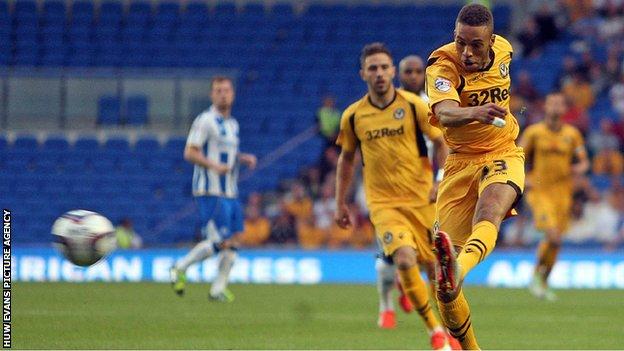 Christian Jolley fires a left-footed shot for Newport County