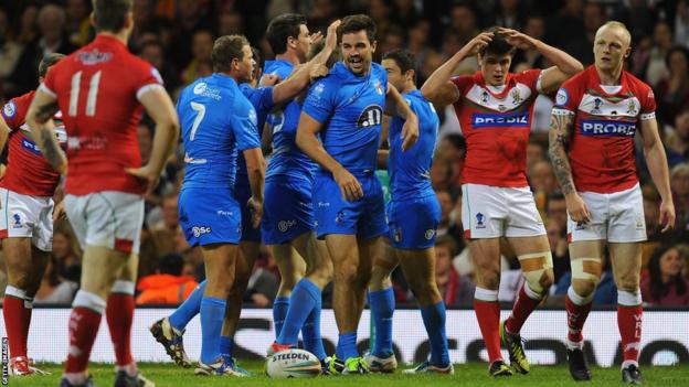Aidan Guerra (c) celebrates after scoring Italy's opening try during the Rugby League World Cup group match against Wales at the Millennium Stadium