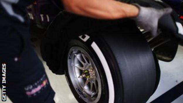 A Red Bull engineer changing a Pirelli tyre