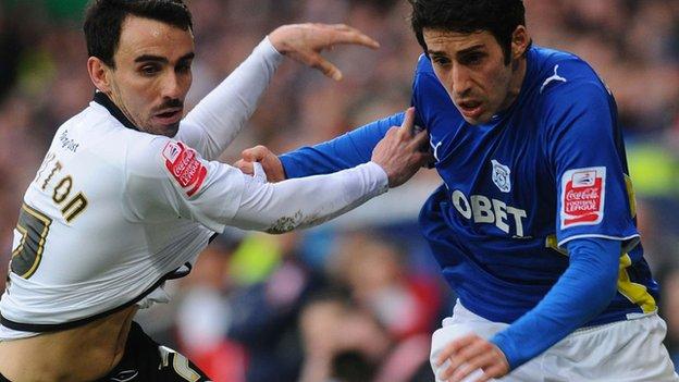 Leon Britton and Peter Whittingham tangle during the last match between Cardiff and Swansea