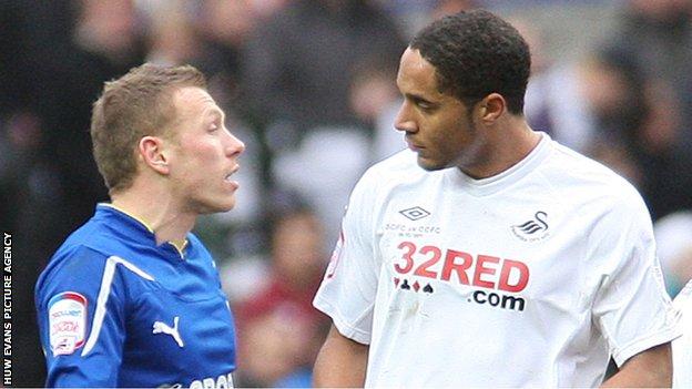 Ashley Williams and Craig Bellamy chat following the last derby match bewteen Cardiff City and Swansea City