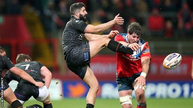 Munster's Dave O'Callaghan blocks a kick from Tito Tibaldi of Ospreys