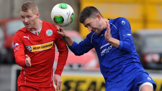 Cliftonville's Martin Murray competes against Cameron Grieve of Dungannon Swifts during the 2-2 draw at Solitude