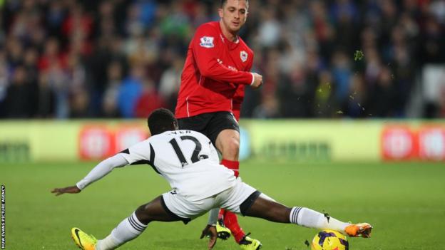 Swansea's Nathan Dyer stretches to block a pass from Andrew Taylor of Cardiff