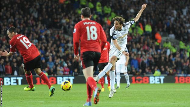 Swansea forward Michu goes closest to breaking the deadlock in a disappointingly subdued first half of the south Wales derby but his shot is well parried by Cardiff goalkeeper David Marshall