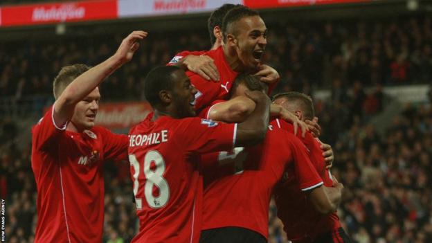 Cardiff players mob Stephen Caulker after his header puts them ahead against Swansea