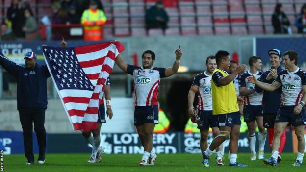 United States players celebrate their victory over Wales with a lap of honour at Wrexham's Racecourse Ground.
