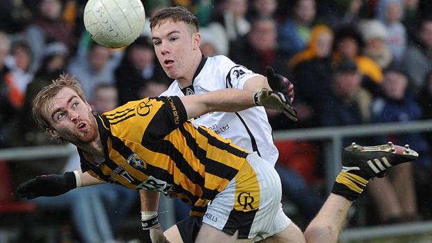 Crossmaglen's Conor O'Neill feels the force of Martin Devlin's tackle in the Newry showdown