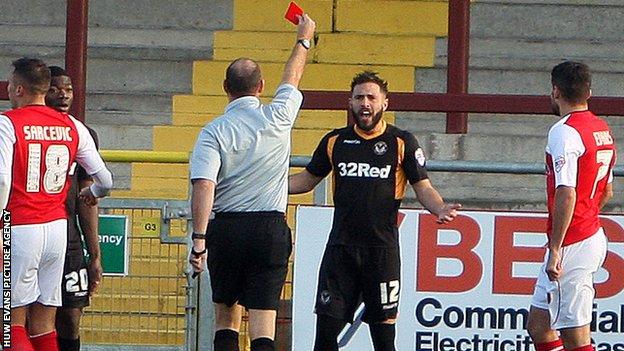 Newport's Robbie Willmott receives a red card from referee Andy Haines