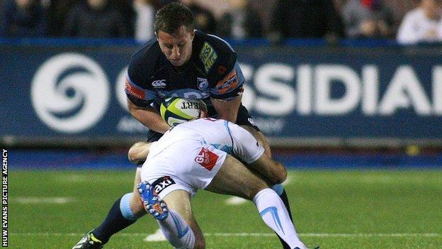 Cardiff Blues' Tom Davies is tackled by Worcester's Paul Hodgson