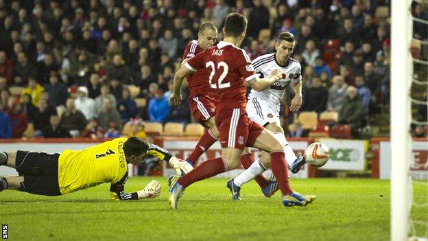 Jamie Walker slips the ball past Aberdeen goalie Jamie Langfield to make it 1-1