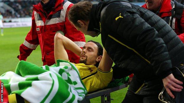 Borussia Dortmund defender Neven Subotic is carried off on a stretcher against Wolfsburg