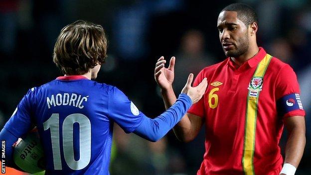 Ashley Williams (right) shakes hands with Croatia's Luka Modric in March, 2013