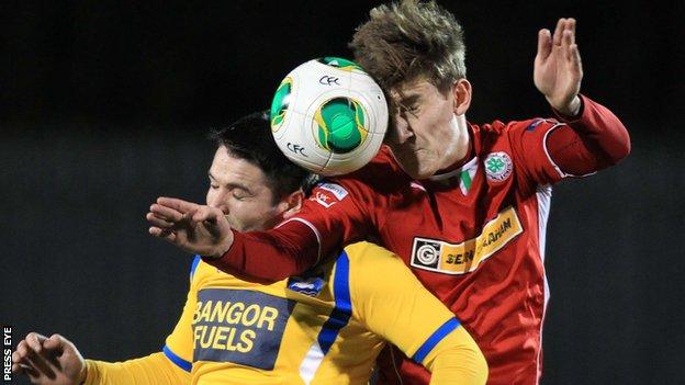 Dominic Melly goes for a high ball with Cliftonville's Paddy McNally