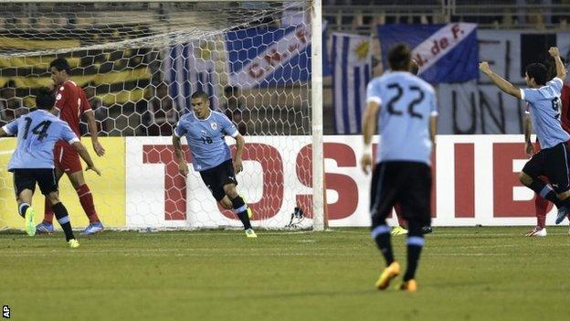 Uruguay celebrate Maxi Pereira's opener
