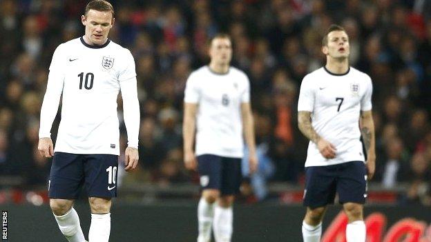 Wayne Rooney (left) and Jack Wilshere (right) show their disappointment at Wembley