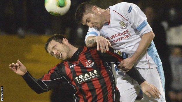 Sean Cleary of Crusaders is beaten to the high ball by Ballymena's Davy Munster