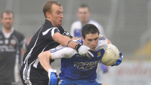 Kilcoo's Gerard McEvoy gets to grips with Ballinderry opponent Gareth McKinless at the Atheltic Grounds in Armagh