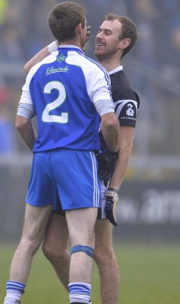 Ballinderry defender Ryan Scott, who was one of four players sent off, has a close encounter with smiling Kilcoo player Gary McEvoy