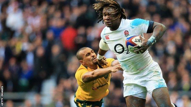 Marland Yarde of England evades a tackle from Will Genia of Australia