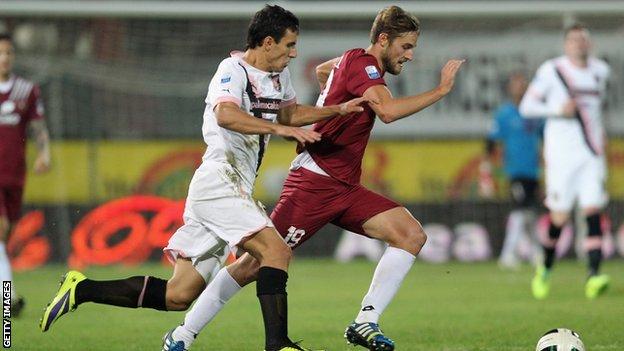 Nicola Rogoni of Reggina competes for the ball with Sinisa Andelkovic of Palermo