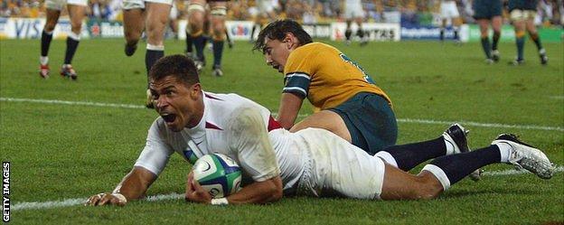 Jason Robinson celebrates as he dives over the line to score England's try